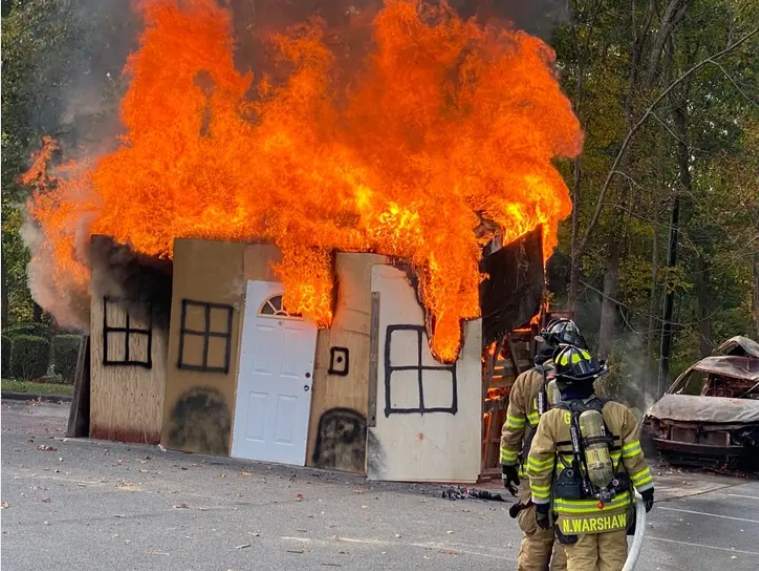 Golden's Bridge firefighters attack fire during dramatic demonstration of live-burn of a small house structure at the GBFD's annual Community Day event at the firehouse. (GBFD)