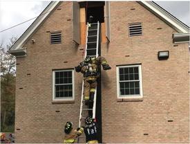 Golden's Bridge firefighters perform a ladder rescue demonstration at a past Community Day event at the Golden's Bridge firehouse. 