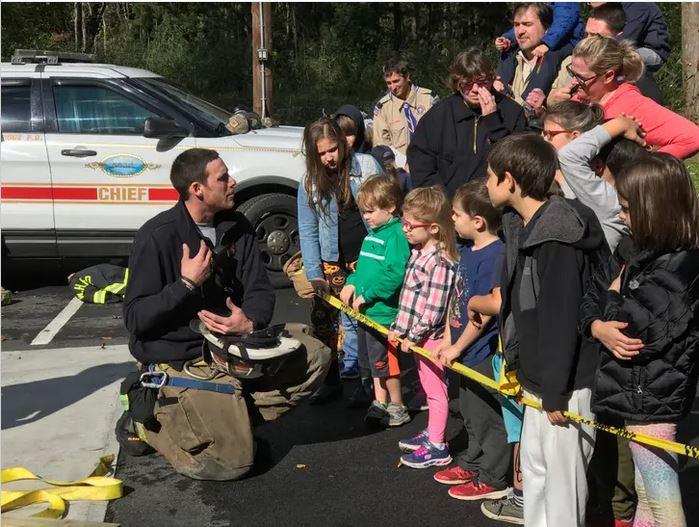 Assistant Fire Chief James McManus talks to children about fire safety at a past Community Day event at the Golden's Bridge firehouse.